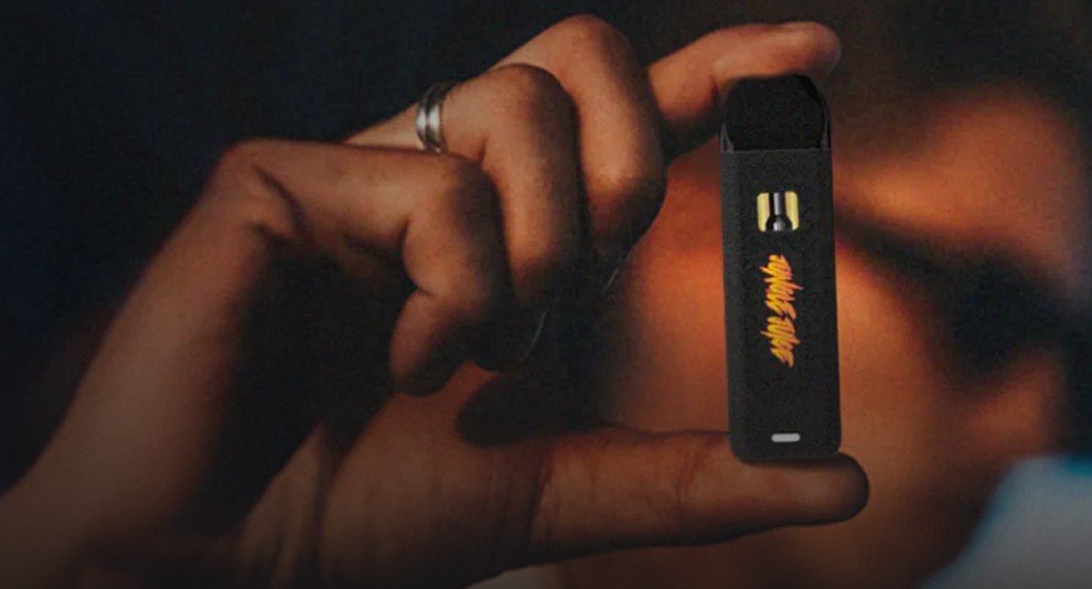 Hand holding a black Jungle Juice vape device